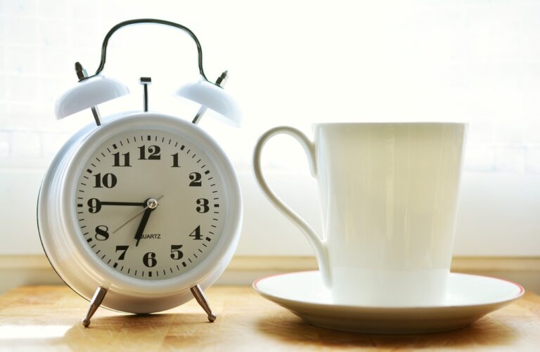 Anti-aging Tip #1 - Intermittent Fasting; Photo of a clock and a coffee mug.