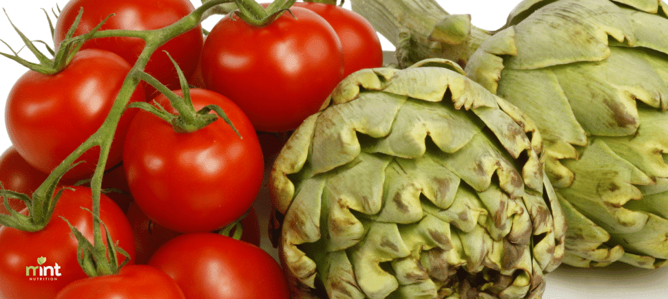 Photo of fresh tomatoes and artichokes for use in a roasted tomato and artichoke recipe