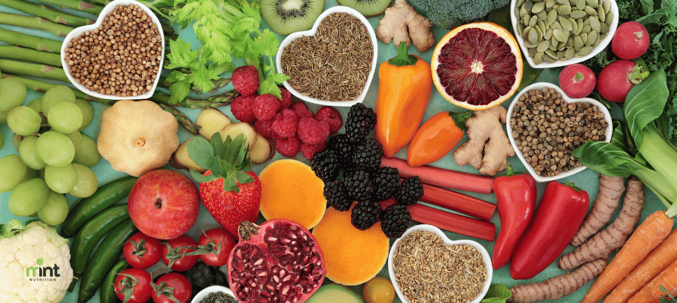 A photo of colorful fruits, vegetables, and heart-healthy foods with a MINT Nutrition logo in the left corner