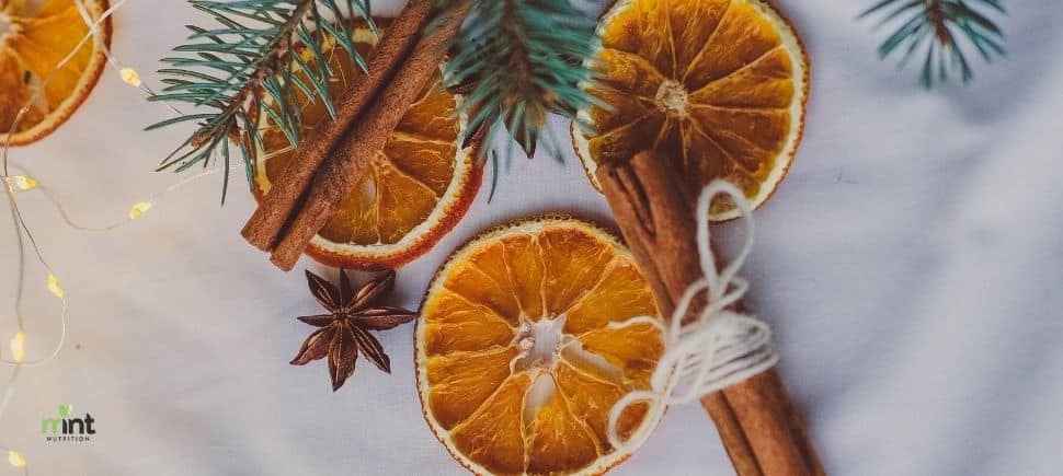 Dried orange slices, cinnamon sticks, and star anise with evergreen sprigs—cozy winter vibes for a Mooresville, NC meal planning and winter mood article.