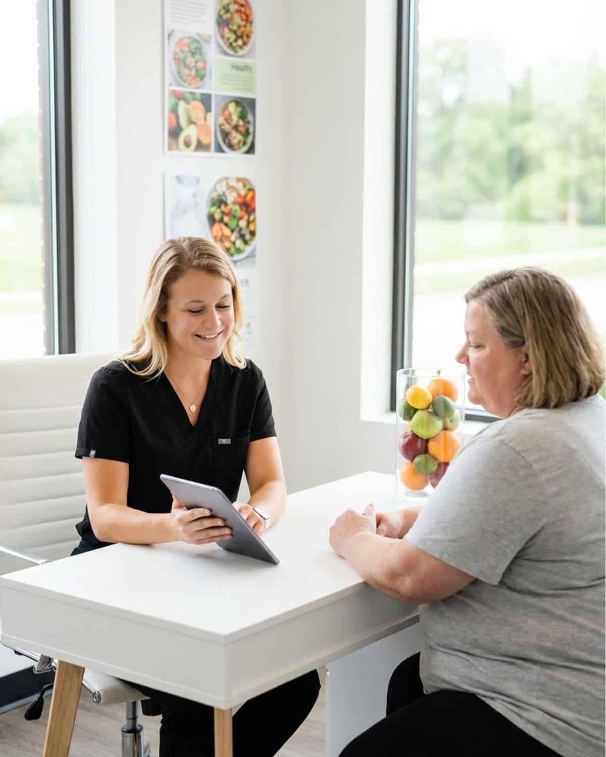 MINT Nutrition dietitian reviewing a personalized nutrition plan during a weight management counseling session in Mooresville, NC.