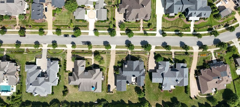 Aerial view of a suburban neighborhood, symbolizing water-damaged homes in Charlotte and Mooresville, NC that can trigger CIRS.