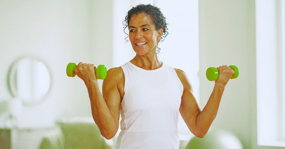 Older woman strength training with dumbbells for muscle building and healthy aging